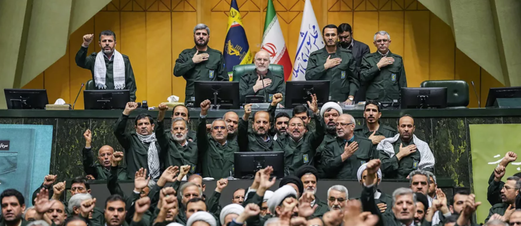 Members of Iran's parliament dressed in IRGC uniforms chant "Death to America" ​​during a session in Tehran (AFP)