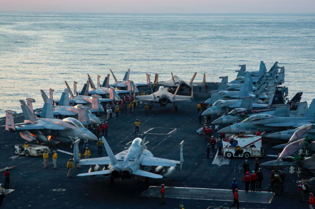 fighter jets on a carrier ship